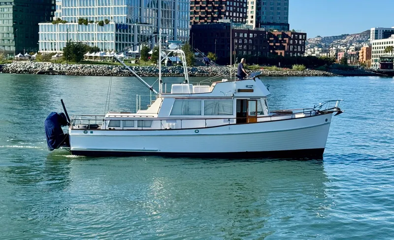 Slide: The Image of 1979 Grand Banks Classic yacht cruising in urban waterfront setting. - 3
