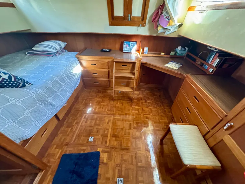 Slide: The Image of 1979 Grand Banks Classic cabin interior with wooden furniture and cozy bed. - 31