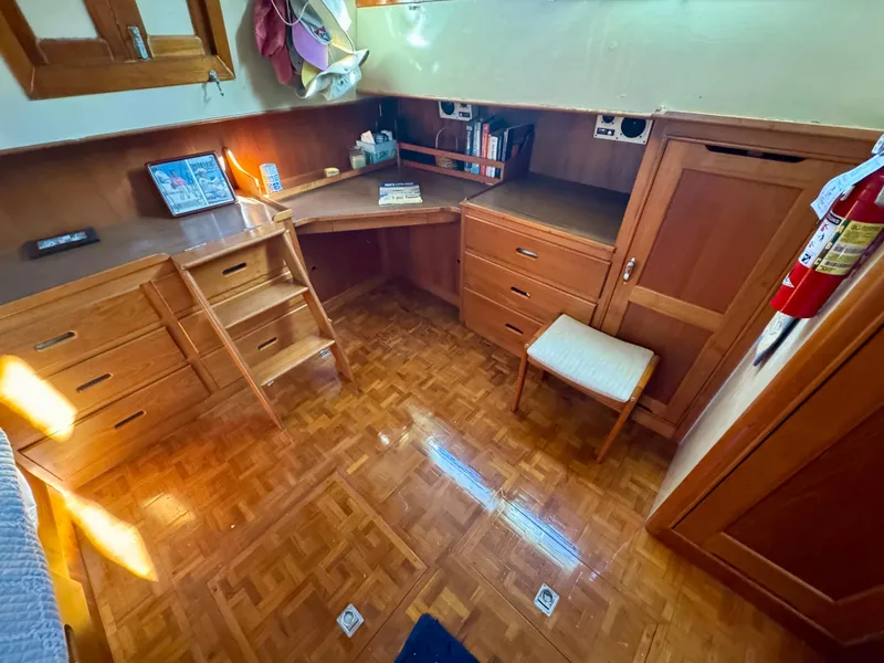 Slide: The Image of 1979 Grand Banks Classic yacht interior with wooden desk and storage cabinets. - 32