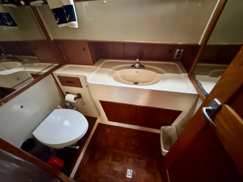 Slide: The Image of 1979 Grand Banks Classic yacht bathroom with sink, toilet, and wood accents. - 34