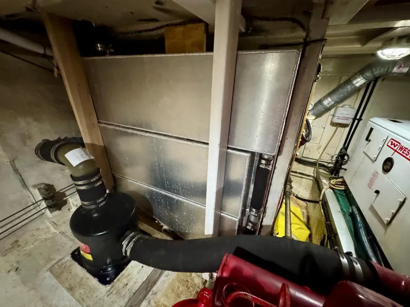 Slide: The Image of Engine room of 1979 Grand Banks Classic boat with visible machinery and equipment. - 38