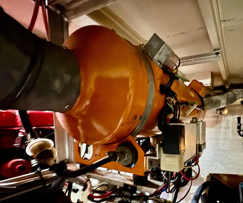 Slide: The Image of Engine room of 1979 Grand Banks Classic boat with visible machinery and wiring. - 43