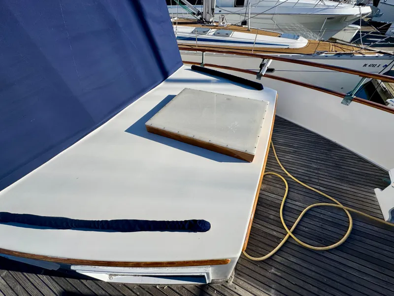 Slide: The Image of 1979 Grand Banks Classic yacht deck with blue cover and wooden accents. - 48