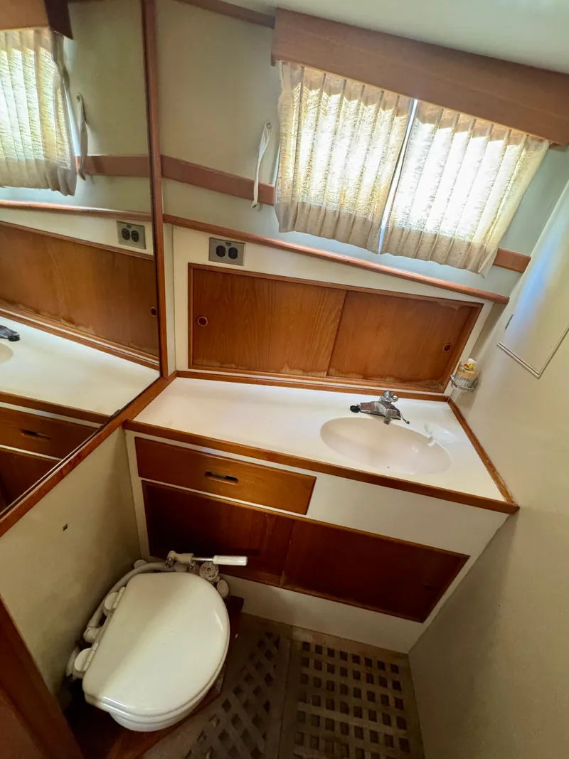 Slide: The Image of 1979 Grand Banks Classic yacht bathroom with wood accents and compact design. - 7