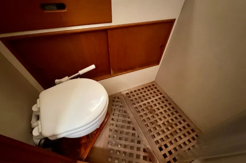 Slide: The Image of 1979 Grand Banks Classic boat bathroom with wooden flooring and compact toilet. - 9