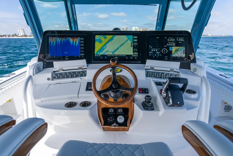 Slide: The Image of 2025 HCB 53 Sueños boat cockpit with advanced navigation displays and controls. - 13