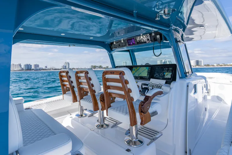 Slide: The Image of Luxurious 2025 HCB 53 Sueños boat interior with modern helm and seating. - 17