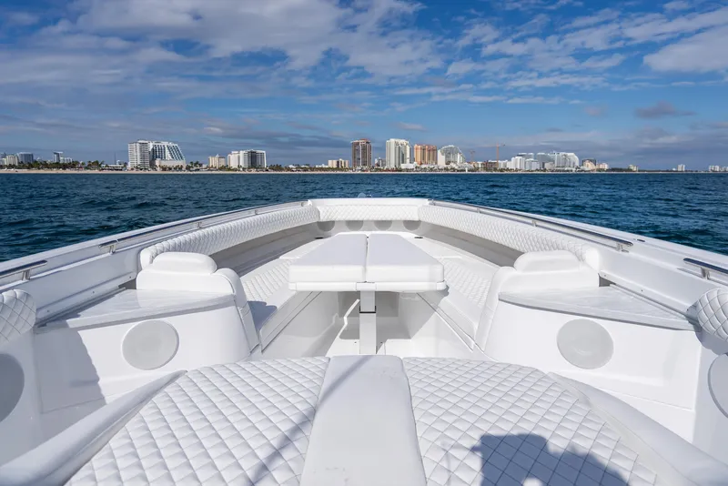 Slide: The Image of 2025 HCB 53 Sueños luxury boat with city skyline in the background. - 25