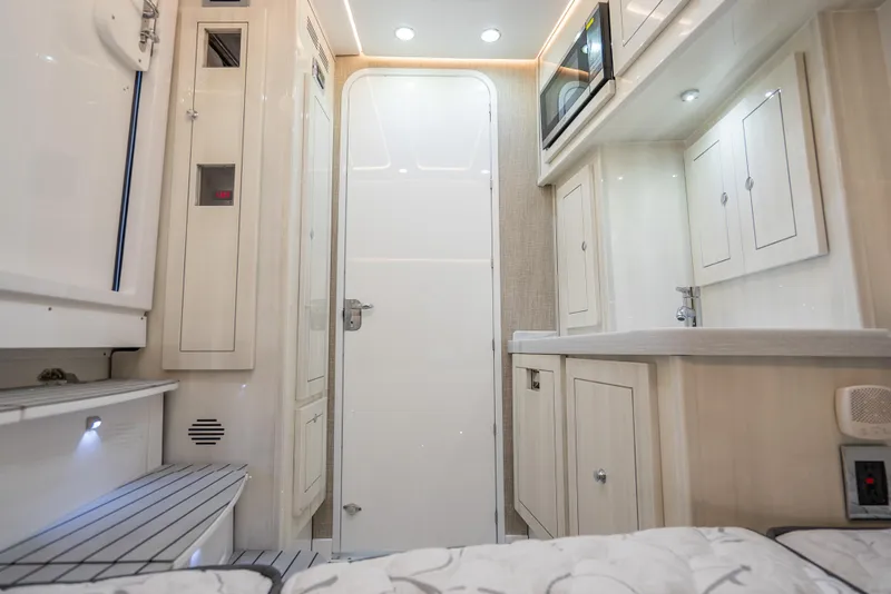 Slide: The Image of Interior of 2025 HCB 53 Sueños boat, featuring modern cabinetry and sleek design. - 32