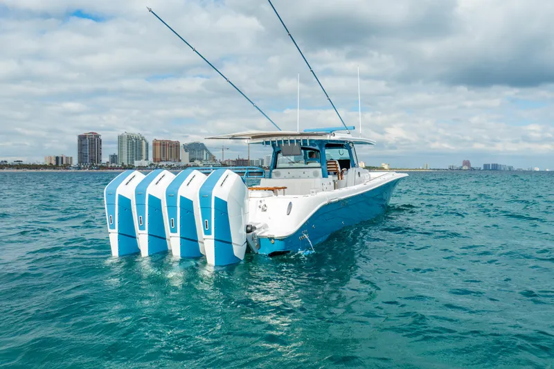 Slide: The Image of 2025 HCB 53 Sueños boat with four engines on open water. - 36