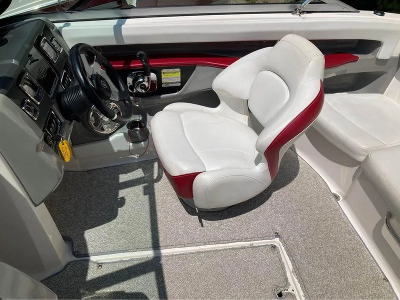Slide: The Image of 2013 Chaparral 196 SSi boat interior with white and red seating, steering wheel, and dashboard. - 3