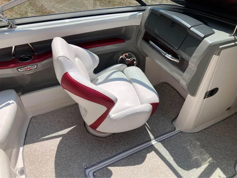 Slide: The Image of 2013 Chaparral 196 SSi boat interior with white and red seating, modern dashboard. - 5