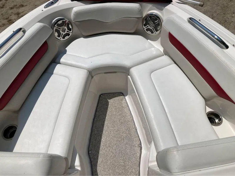 Slide: The Image of 2013 Chaparral 196 SSi boat interior with white and red seating, stainless steel speakers. - 7