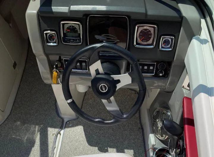 Slide: The Image of Dashboard of a 2013 Chaparral 196 SSi boat with steering wheel and gauges. - 8