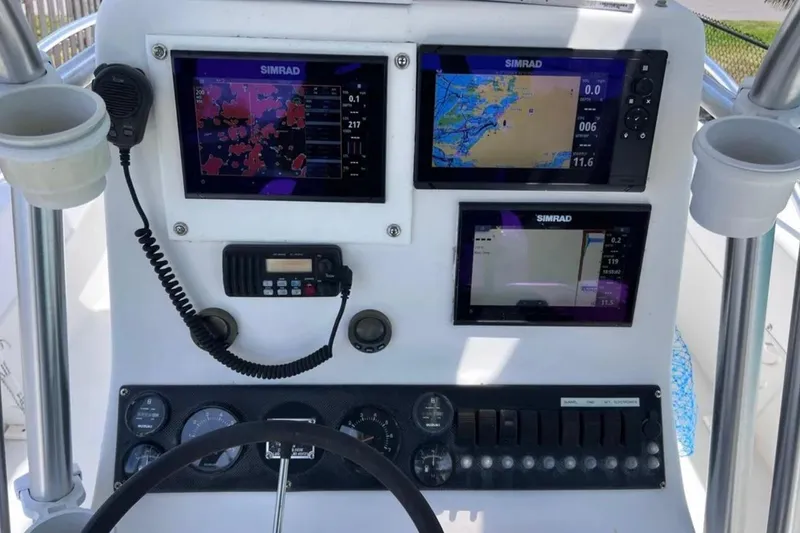 Slide: The Image of Dashboard of 2005 Twin Vee 22 Ocean Classic with Simrad navigation displays. - 14