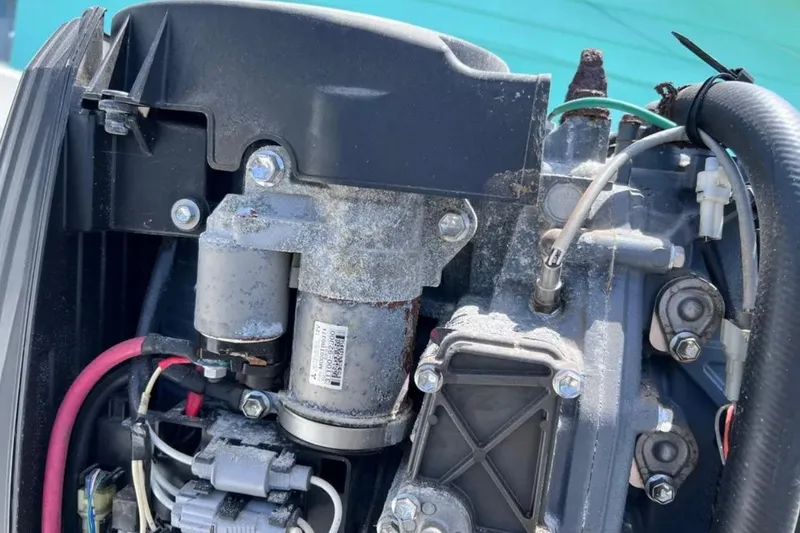 Slide: The Image of Close-up of a 2005 Twin Vee 22 Ocean Classic boat engine components. - 16
