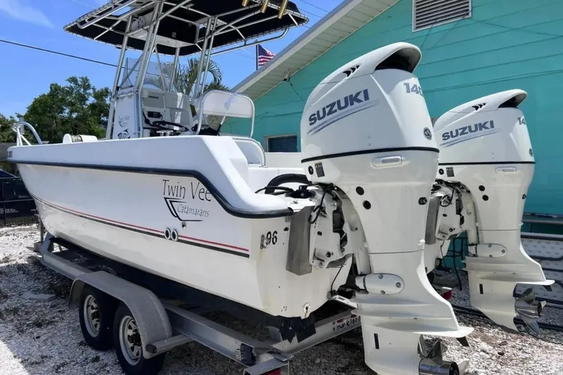 Slide: The Image of 2005 Twin Vee 22 Ocean Classic boat with dual Suzuki outboard motors on a trailer. - 3