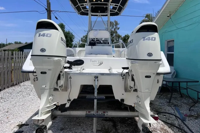 Slide: The Image of 2005 Twin Vee 22 Ocean Classic boat with dual Suzuki 140 engines, parked outdoors. - 4