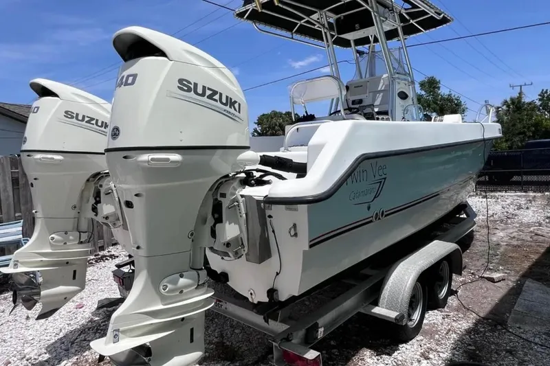 Slide: The Image of 2005 Twin Vee 22 Ocean Classic boat with dual Suzuki outboard motors on a trailer. - 7