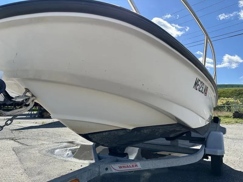 Slide: The Image of 2005 Boston Whaler 130 Super Sport boat on trailer, sunny day. - 3