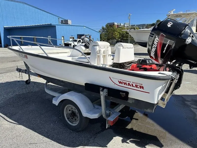 Slide: The Image of 2005 Boston Whaler 130 Super Sport boat on trailer with Mercury engine. - 6