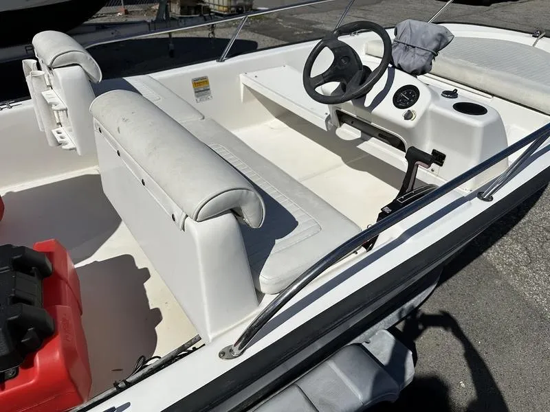 Slide: The Image of 2005 Boston Whaler 130 Super Sport interior with steering wheel and seating. - 7