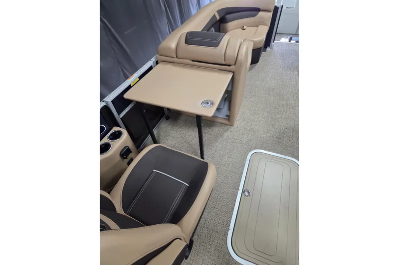 Slide: The Image of 2025 Barletta Cabrio 22QC interior with beige seating and foldable table. - 9