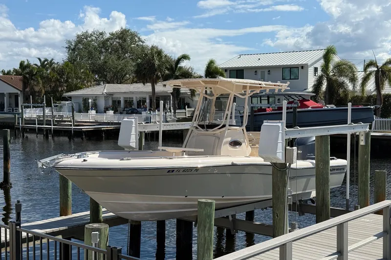 Slide: The Image of 2015 Grady-White 251 Coastal Explorer boat docked by waterfront homes. - 0