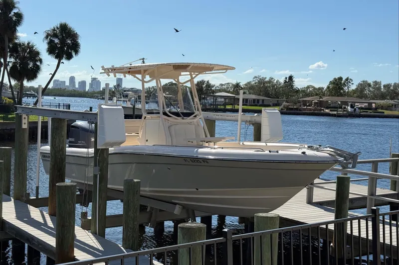 Slide: The Image of 2015 Grady-White 251 Coastal Explorer boat docked by a scenic waterfront. - 1