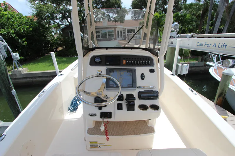 Slide: The Image of 2015 Grady-White 251 Coastal Explorer boat console with steering wheel and navigation controls. - 15