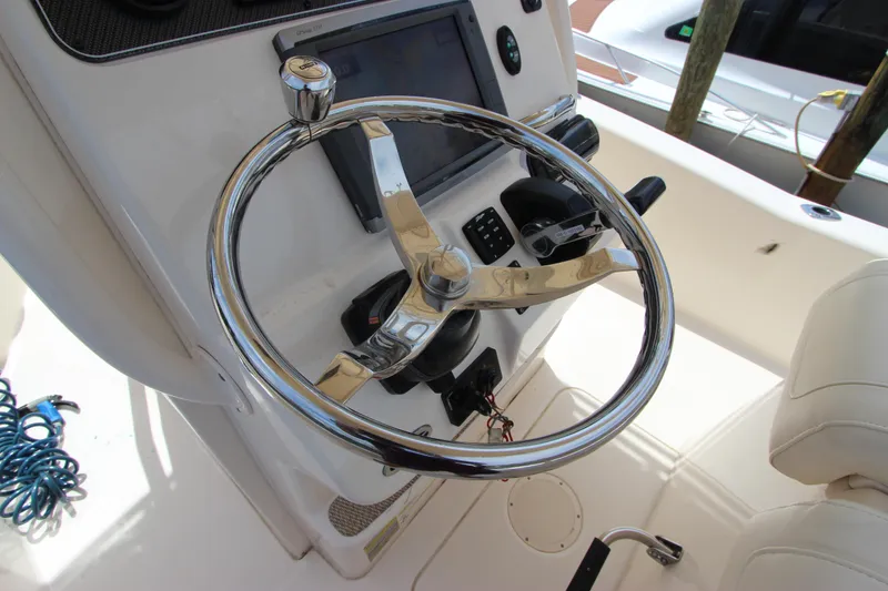 Slide: The Image of Steering wheel of 2015 Grady-White 251 Coastal Explorer boat, featuring modern controls. - 16