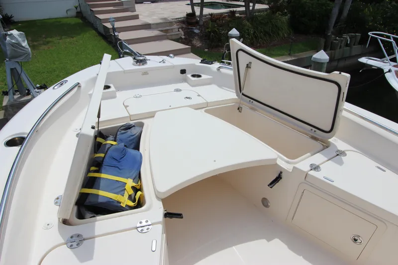 Slide: The Image of 2015 Grady-White 251 Coastal Explorer boat with open storage compartments and life jackets. - 26