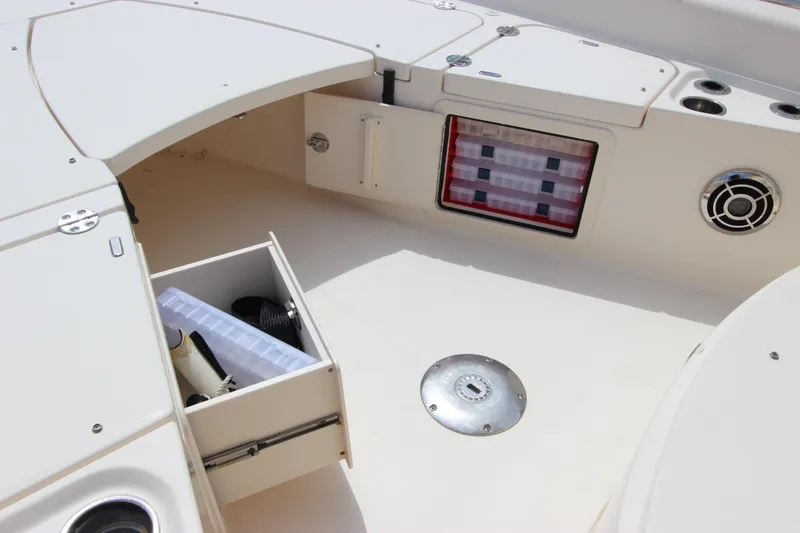 Slide: The Image of 2015 Grady-White 251 Coastal Explorer boat interior with storage compartments and seating area. - 27