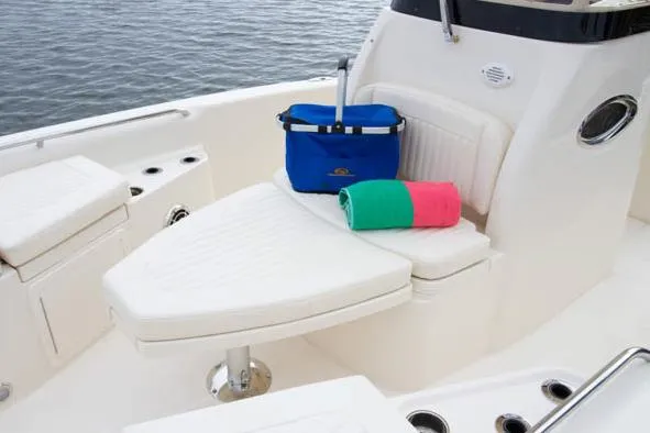 Slide: The Image of 2015 Grady-White 251 Coastal Explorer boat interior with seating, cooler, and towels. - 29