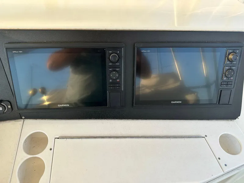 Slide: The Image of Garmin navigation screens on 1996 Viking 43 Convertible Sportfish boat dashboard. - 14