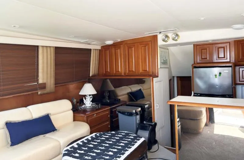 Slide: The Image of Interior of 1996 Viking 43 Convertible Sportfish with cozy seating and wooden cabinetry. - 17