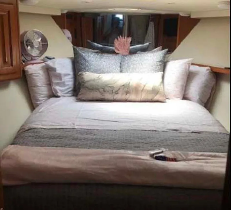 Slide: The Image of Cozy bedroom in 1996 Viking 43 Convertible Sportfish yacht with plush bedding and fan. - 20