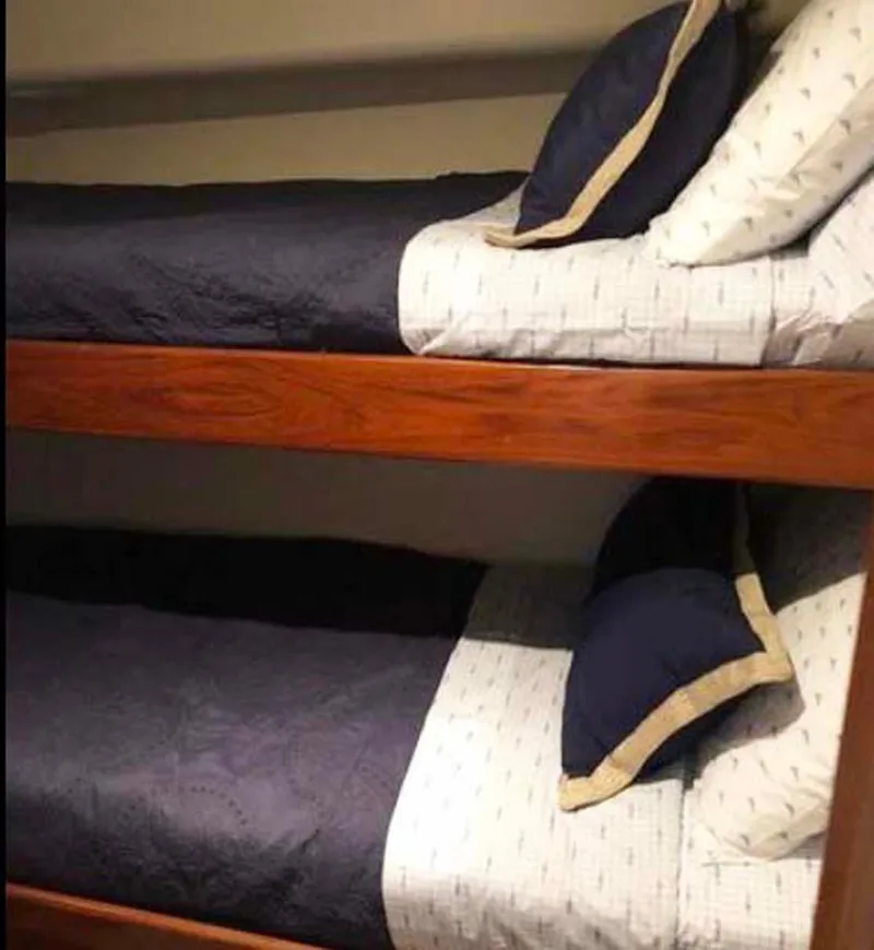 Slide: The Image of Bunk beds in 1996 Viking 43 Convertible Sportfish cabin with navy bedding. - 21