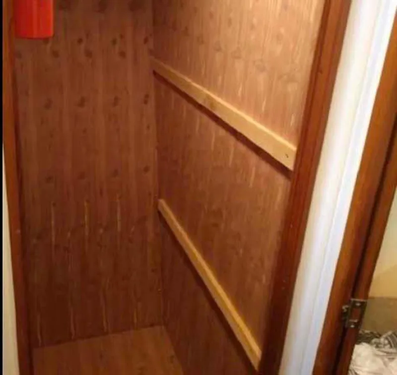 Slide: The Image of Wood-paneled closet interior on a 1996 Viking 43 Convertible Sportfish boat. - 22