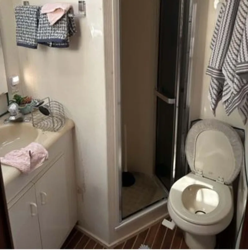 Slide: The Image of Bathroom interior of 1996 Viking 43 Convertible Sportfish yacht, featuring shower and toilet. - 24