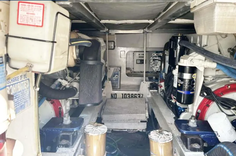 Slide: The Image of Engine room of 1996 Viking 43 Convertible Sportfish boat, showcasing mechanical components. - 26