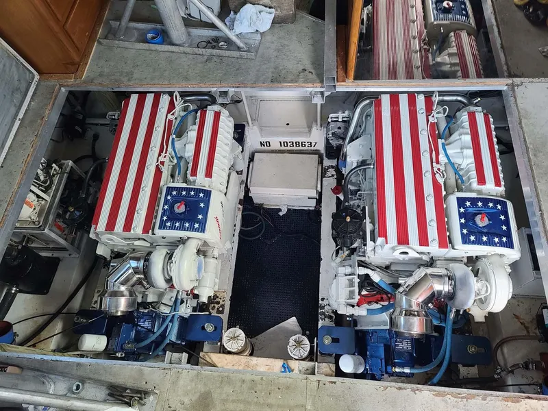 Slide: The Image of Engine room of 1996 Viking 43 Convertible Sportfish with American flag-themed engine covers. - 27