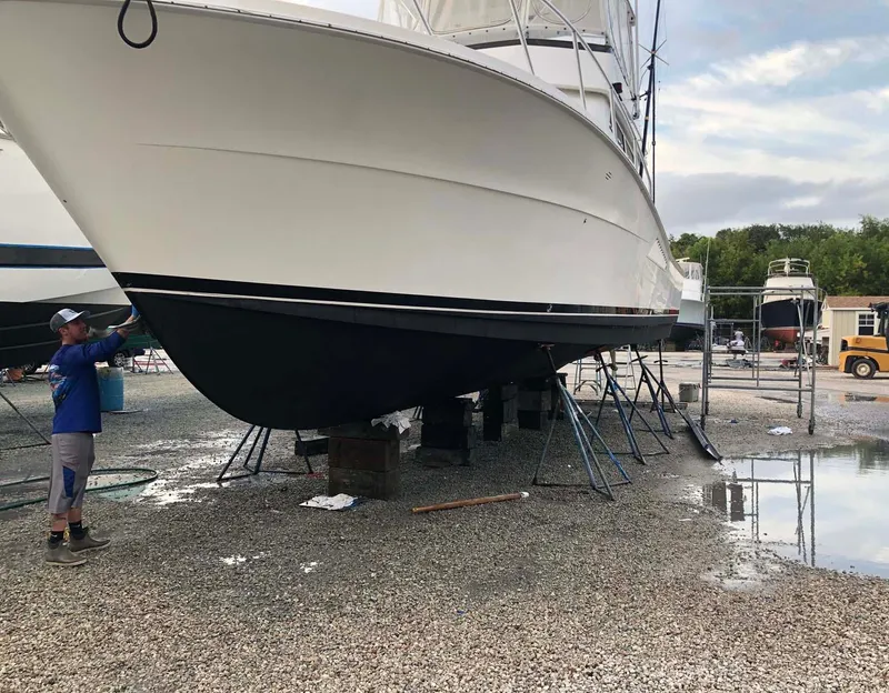 Slide: The Image of 1996 Viking 43 Convertible Sportfish boat on dry dock, maintenance underway. - 31