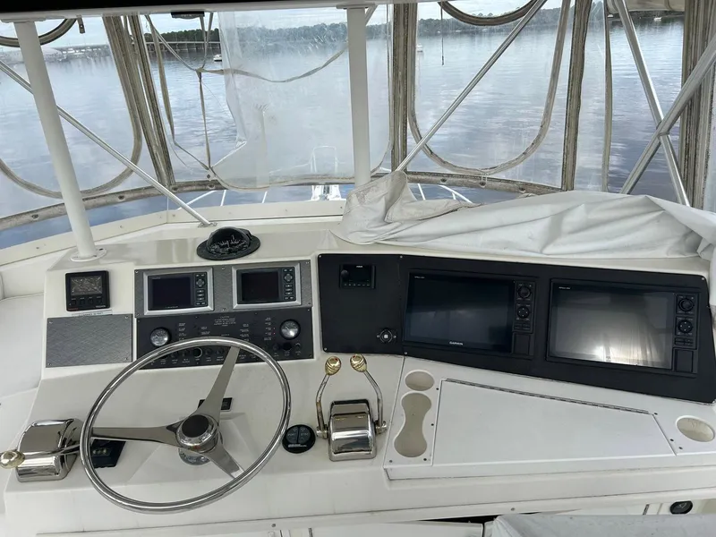 Slide: The Image of Helm of 1996 Viking 43 Convertible Sportfish with navigation equipment and steering wheel. - 6