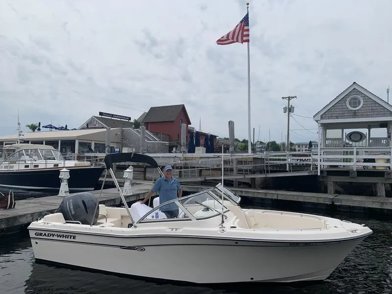Slide: The Image of 2017 Grady-White 205 Freedom boat docked at marina with American flag. - 3