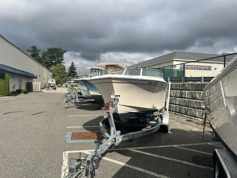 Slide: The Image of 2017 Grady-White 205 Freedom boat on trailer in parking lot under cloudy sky. - 4