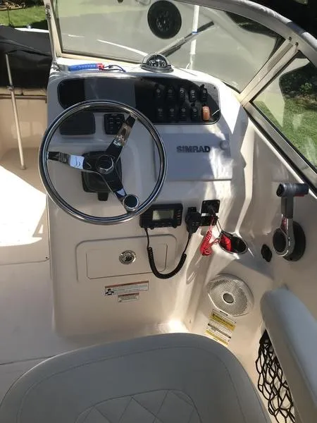 Slide: The Image of 2017 Grady-White 205 Freedom boat dashboard with steering wheel and controls. - 5