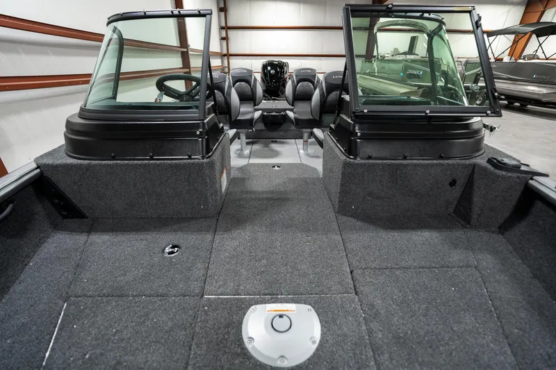 Slide: The Image of 2025 Lund 1875 Impact boat interior with dual consoles and spacious seating. - 13