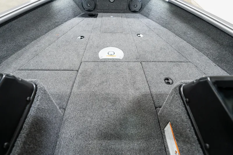 Slide: The Image of Interior view of 2025 Lund 1875 Impact boat, featuring spacious carpeted deck. - 18
