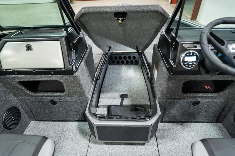 Slide: The Image of 2025 Lund 1875 Impact boat interior with open storage compartment and dashboard. - 24